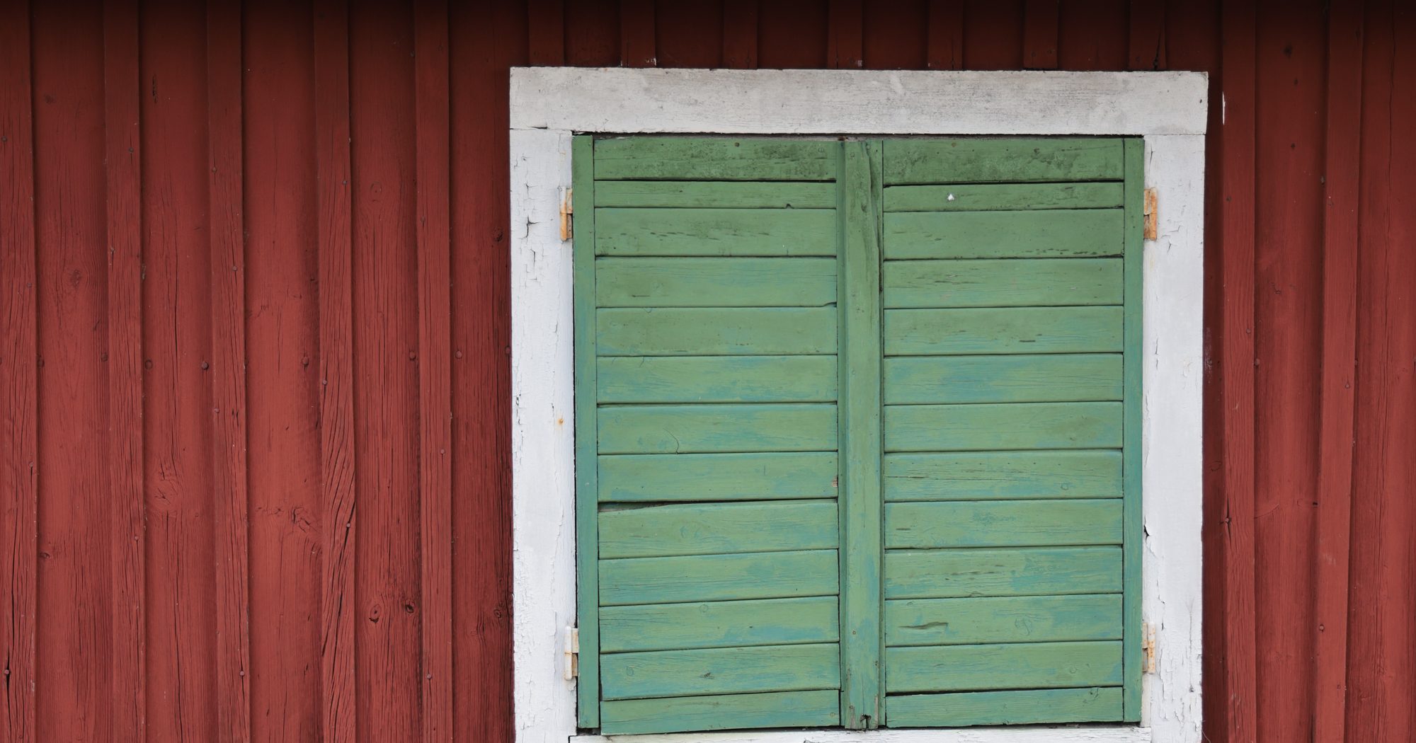 Falu red cabin with green shutters