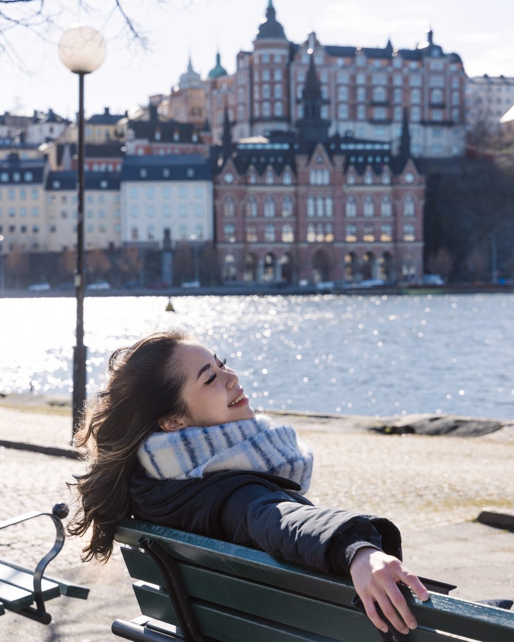 Portrait in a white dress under the arches of Stockholm City Hall