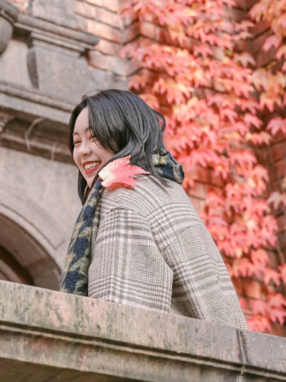 Smiling portrait among red autumn leaves