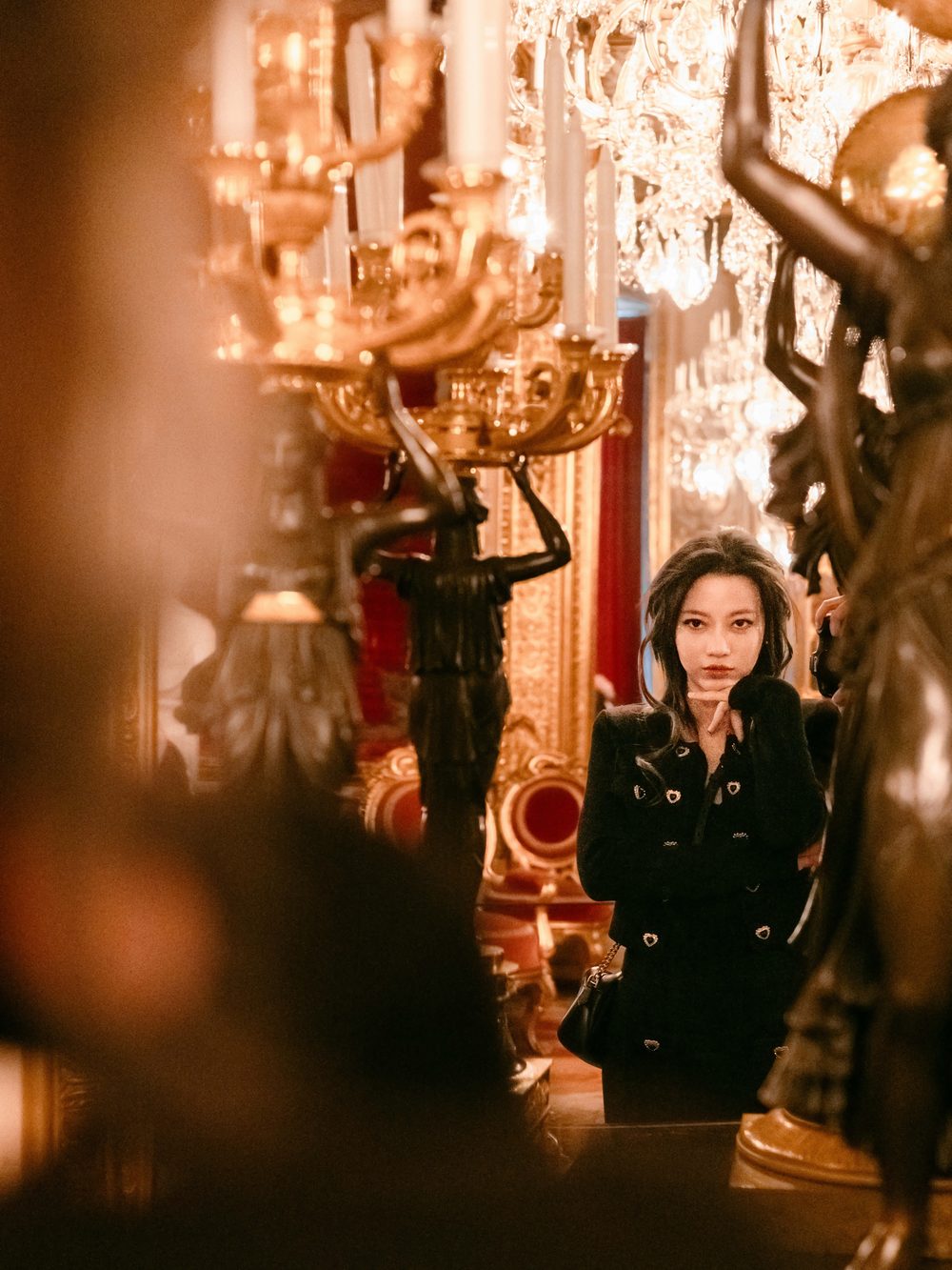 Portrait among candelabras in golden indoor light